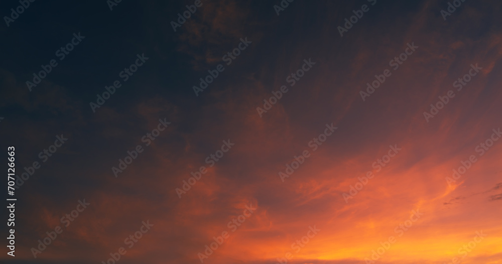 Dusk sky on twilight after sundown with horizon orange, red sunlight sunset clouds in golden hour and dark blue sky background 