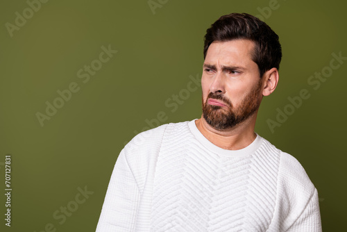 Photo of irritated man dressed white trendy clothes avoiding smell looking empty space isolated on khaki color background © deagreez
