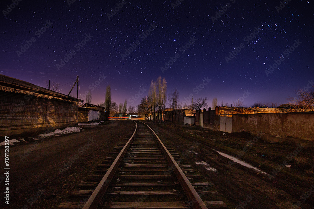 Railway under a starry sky in the city. Railway under a starry sky in the city.
