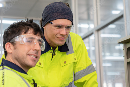 Technician engineers check and repair automatic robotic machines at the industrial factory, Workers work with focused repairing in the industry.