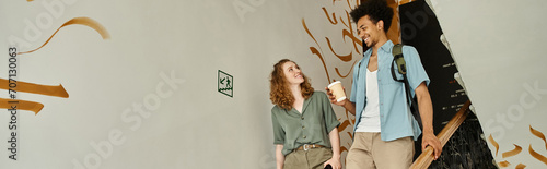 Εκτύπωση καμβά carefree african american man with paper cup walking with girlfriend on staircas