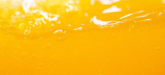 Close up bright orange juice splash texture for health and nature waves, Beautiful waves curve and little bubbles smooth for garphic design and background