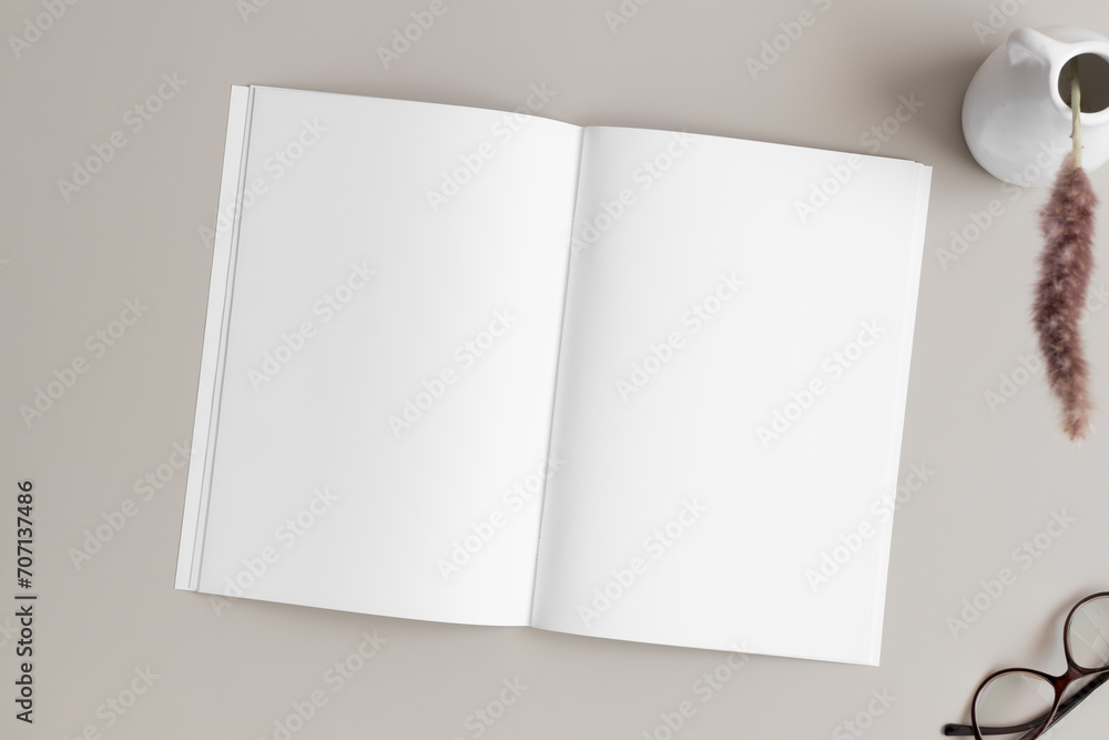 Open magazine mockup with a pampas on the beige table. Open magazine mockup with a pampas on the beige table.