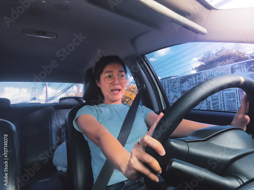 Front view of asian Thai woman shocked face and screaming of car crashing, hitting accident on road while driving go to work, traveling.