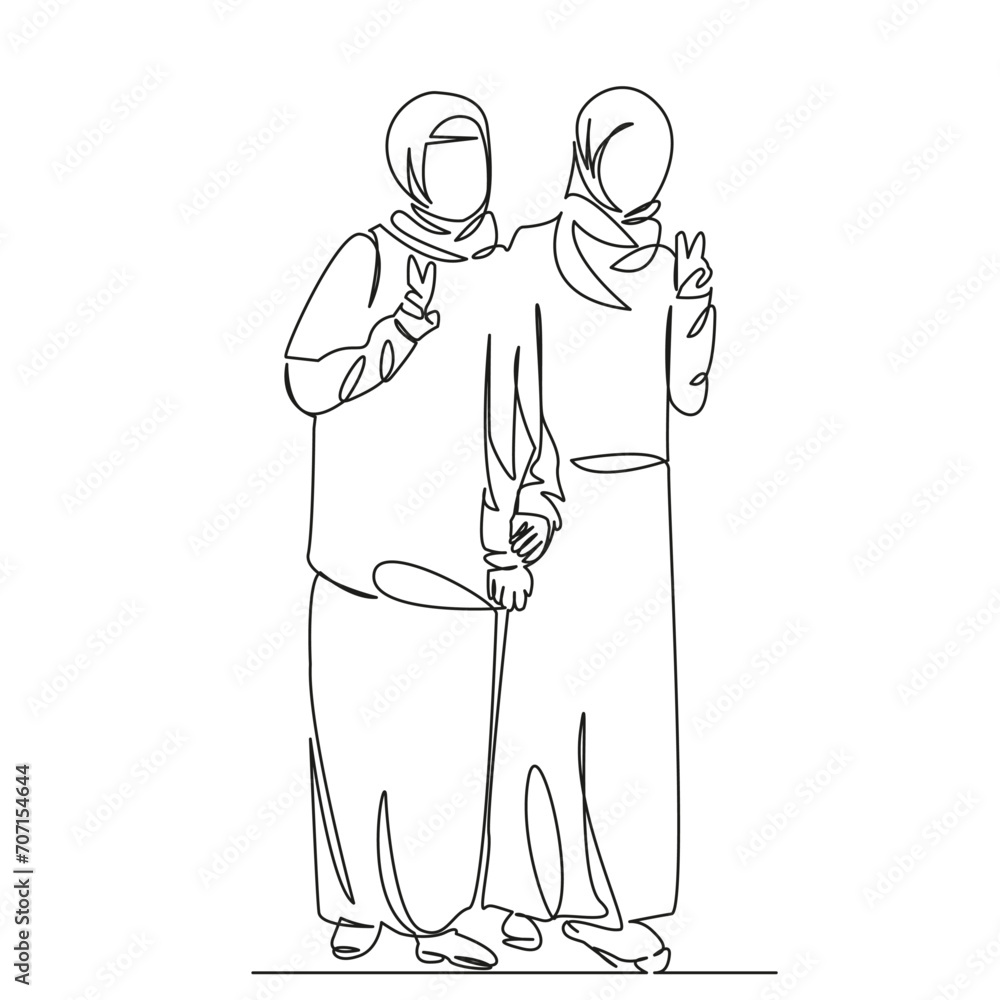 two Muslim girls demonstrate a peace sign with their hands two Muslim girls demonstrate a peace sign with their hands