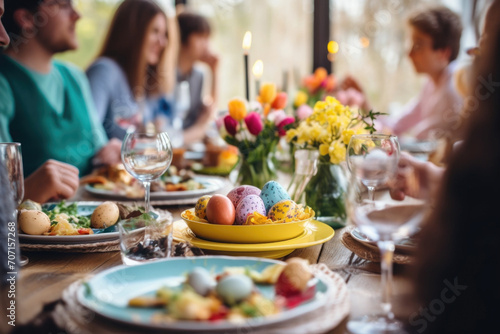 Happy multi generational family having Easter dinner together, table setting with traditional food and spring flowers for Easter celebration