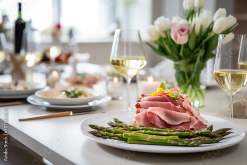 Table setting with meat and vegetables, grilled asparagus and ham photo