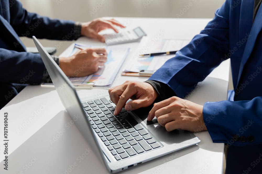 Close up of Asian male company executives working together reviewing business in the office Close up of Asian male company executives working together reviewing business in the office