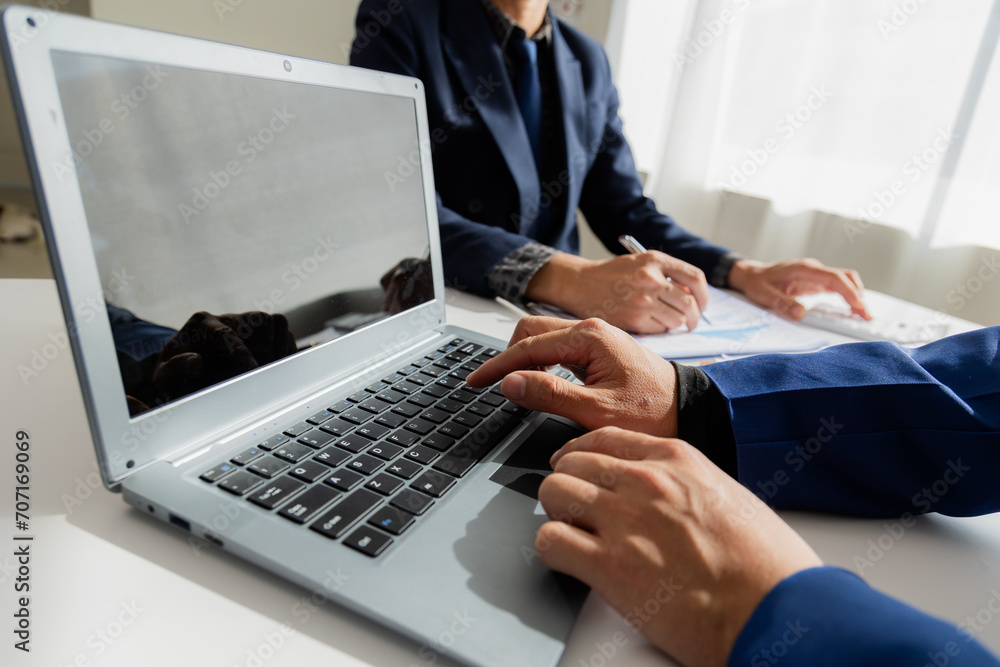 Close up of Asian male company executives working together reviewing business in the office Close up of Asian male company executives working together reviewing business in the office