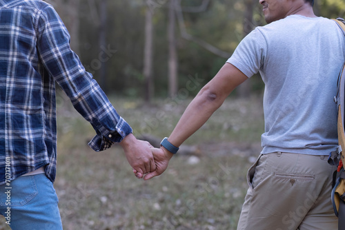 Asian LGBTQ couple. Rear view of gay couple walking together and holding hands.