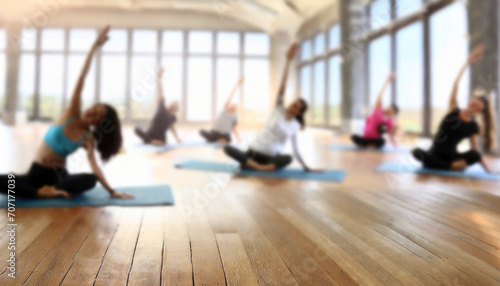 Young people practicing yoga in gym, focus on foreground, blurred background