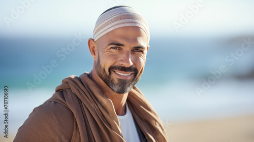 Male happy face portrait of young muslim smiling hispanic arabian guy posing outdoors looking at camera. Tourism pleasure concept