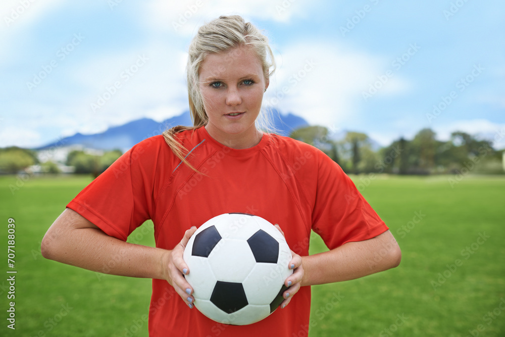 Happy woman, portrait and soccer ball on green grass for sports match, practice or outdoor game. Female person, athlete or football player smile for playing sport, workout or cardio exercise on field