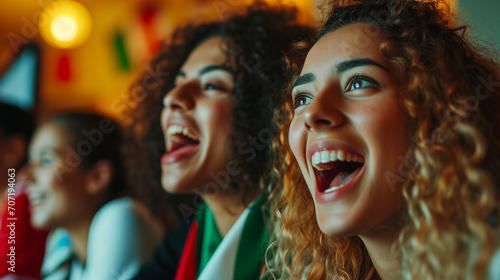 Excited Young Italian Women Soccer Fans Watching European Tournament Match on TV, Expressing Joy and Happiness in Intense Soccer Game Viewing Experience