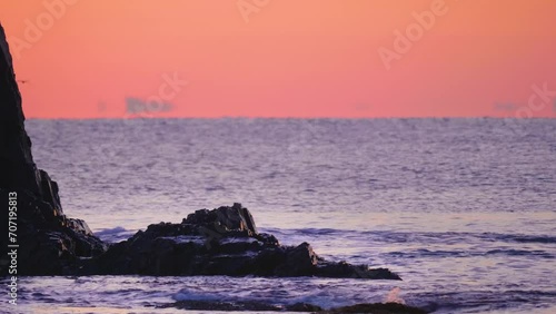 Setting Sun viewed from rocky reef on Paradisos beach in Neos marmaras. photo