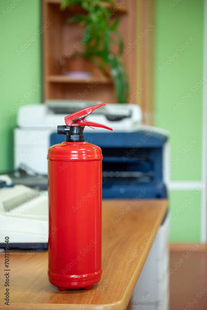 Fire extinguisher in workplace office. Fire safety