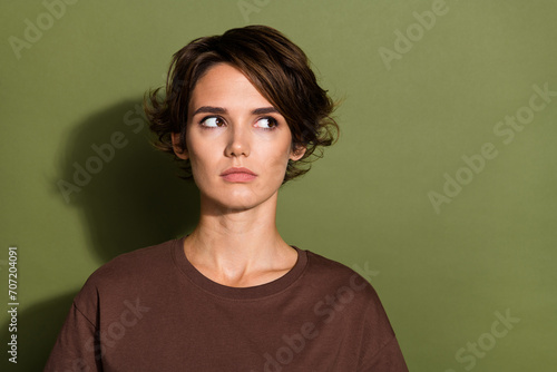 Photo portrait of attractive woman look nervous empty space wear trendy brown clothes isolated on khaki color background