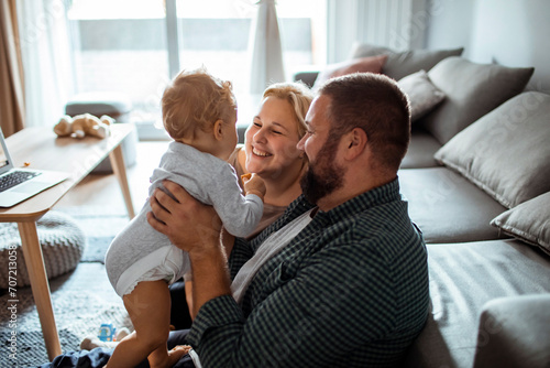 Happy family with baby enjoying time together at home
