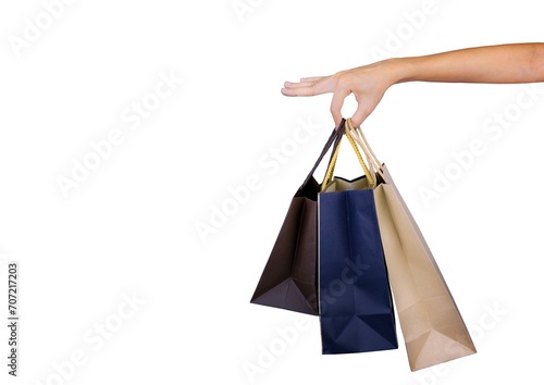 Woman carrying paper shopping bags isolated on white background. Adult woman hand hold three shopping bag with blue and brown color. Customer and shopping bag. Black Friday concept.