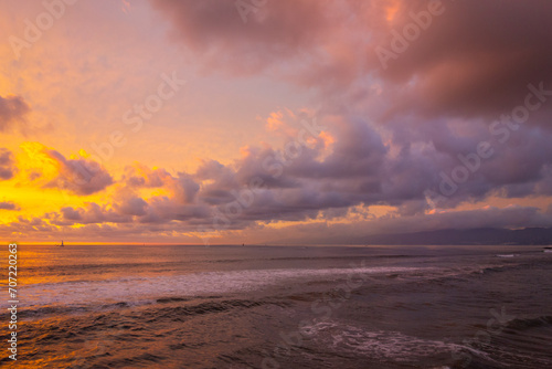 Extremely colorful and sunset and beautiful cloudscape over the Pacific Ocean  with Malibu in the background  taken from  Venice Beach Fishing Pier.