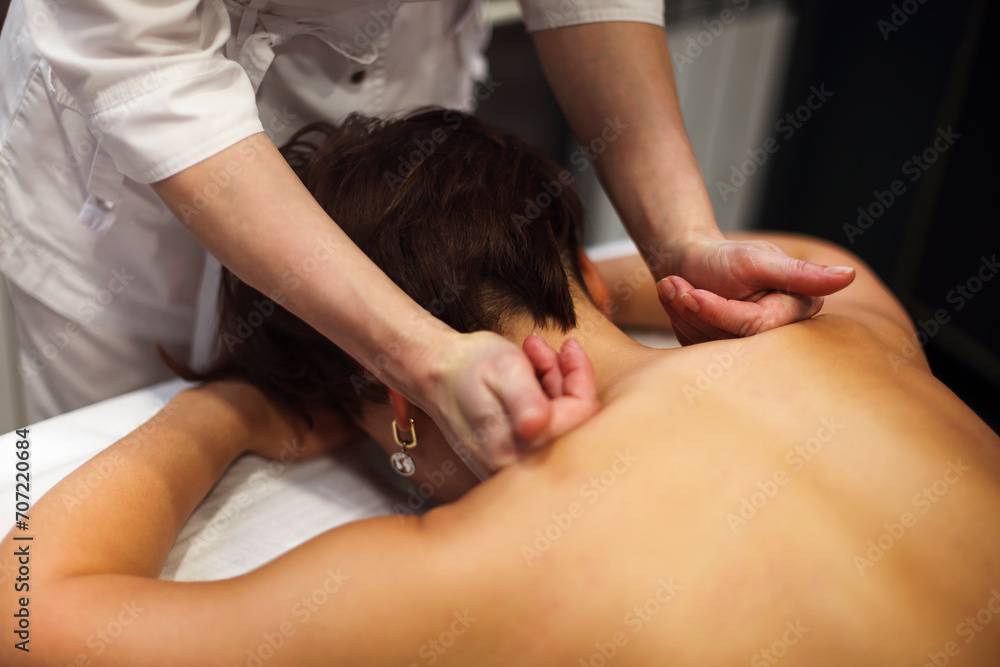 Masseur rubbing shoulders of woman Masseur rubbing shoulders of woman