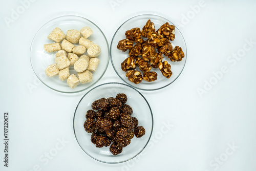 Three Plates Full of Sesame Ladoo, Til ko Laddu, Jaggery Peanuts Laddoo for Maghe Sankranti and Makar Sankranti Festival in Nepal and India photo