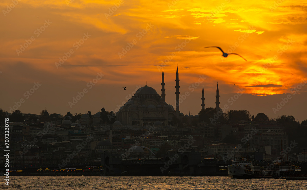 Silhouette of Suleymaniye Mosque at sunset. Golden sky and clouds.