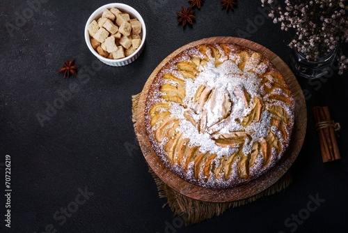 Apple pie with fresh fruits on a wooden table