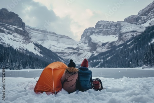 Tourists sitting near winter camp in mountains