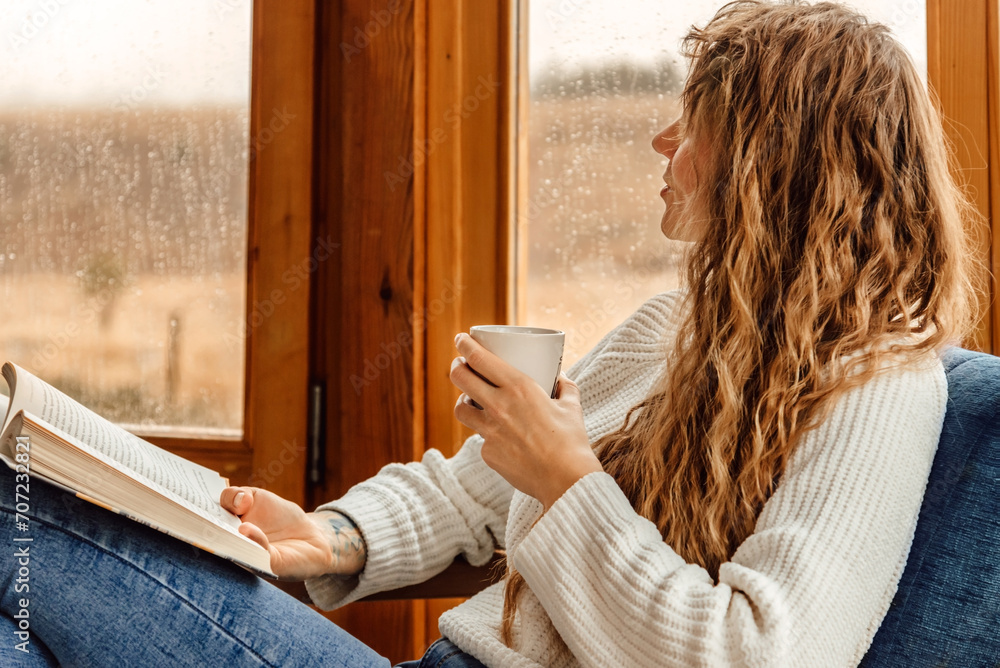 Young Woman Reading Book at Indoor Terrace