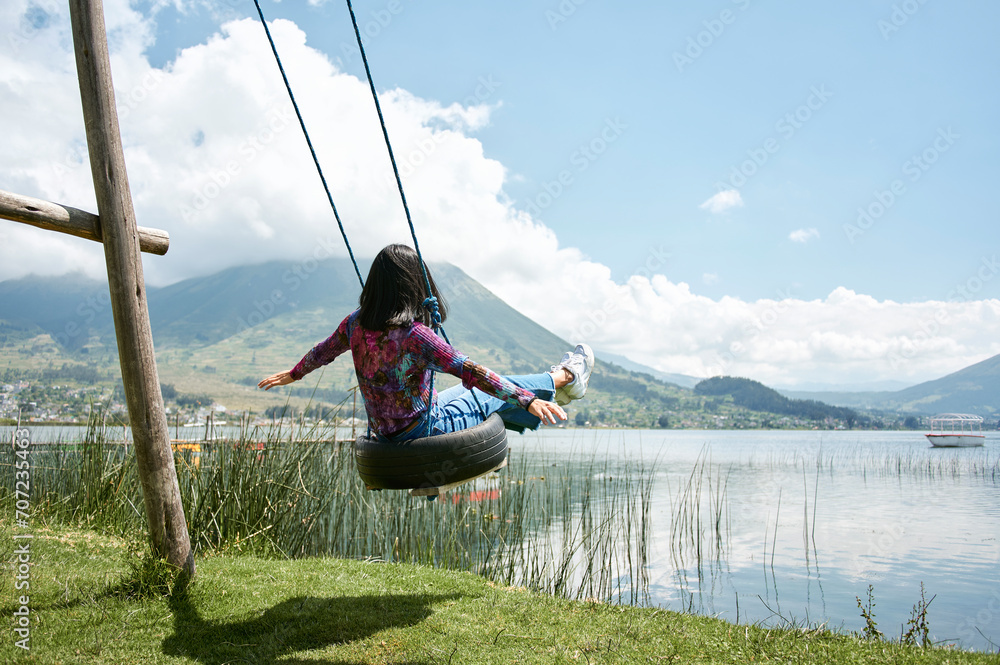 Woman on swing in front of Imbabura volcano, Otavalo, Ecuador