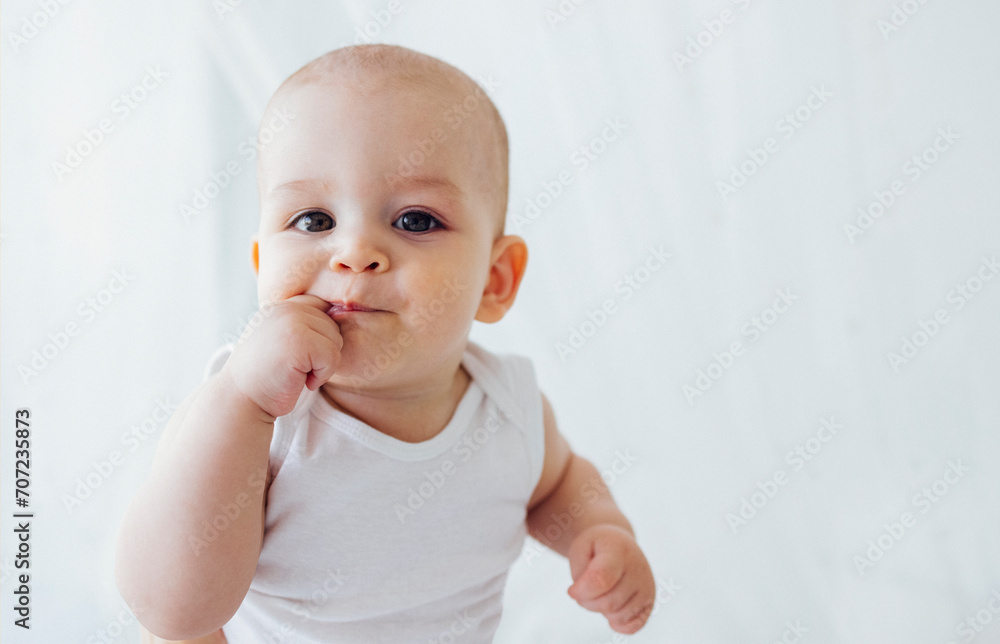 Close up of portrait of sweet baby. Cute little kid licking his finger and looking at camera. Close up of portrait of sweet baby. Cute little kid licking his finger and looking at camera.