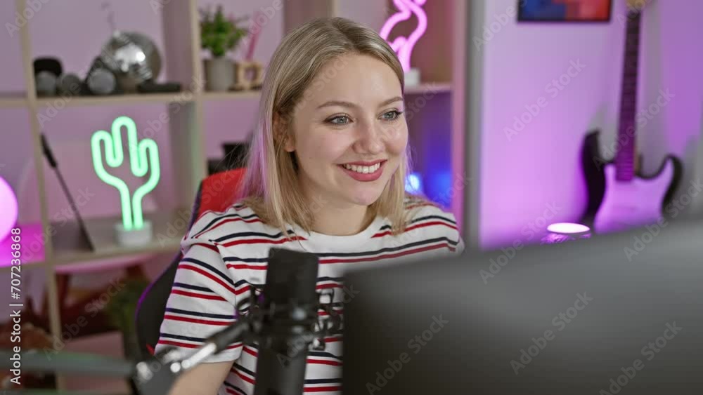 Confident young blonde streamer, a laughing, smiling face looking away, basking in a gaming session