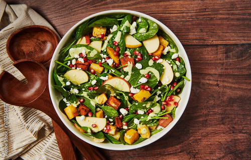 Autumn salad with apples, squash, pomegranate, cheese and spinach photo