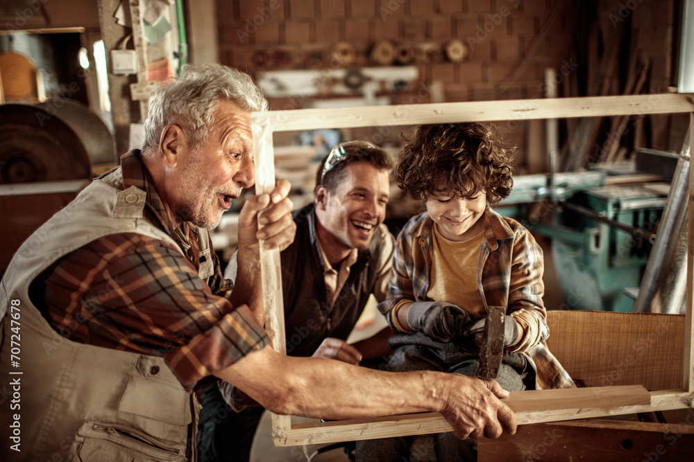 Grandfather, Father, and Son in a Woodworking Workshop Grandfather, Father, and Son in a Woodworking Workshop
