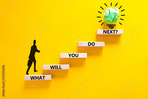 What will you do next symbol. Concept words What will you do next on wooden blocks. Beautiful yellow table yellow background. Businessman icon. Business, what will you do next concept. Copy space. photo