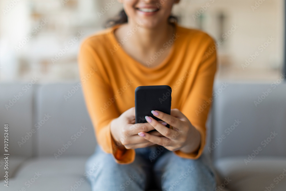 Closeup Shot Of Smiling Young Female Using Smartphone At Home Closeup Shot Of Smiling Young Female Using Smartphone At Home