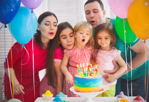 Portrait of a family celebrating birthday of their little daughter