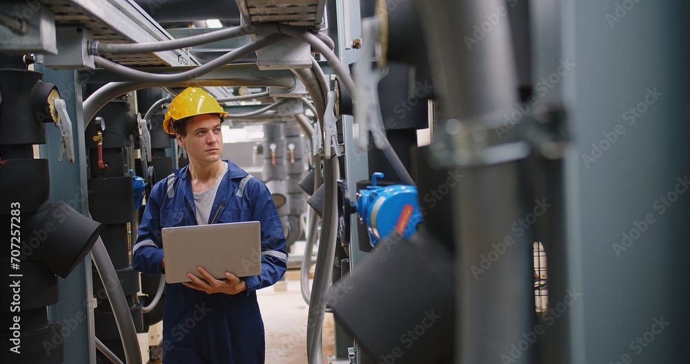engineer using laptop checking industry cooling air conditioner water cooling tower air chiller of large industrial building to control air system at construction site - obrazy, fototapety, plakaty 