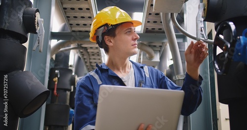 Photography engineer using laptop checking industry cooling air conditioner water cooling to