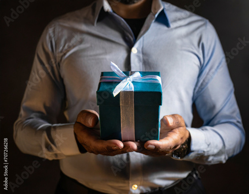 A man holding a gift box. Birthday, corporate event, St Valentine day gift concept