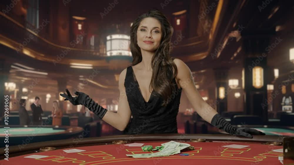 Attractive woman in black dress at poker table for blackjack game in casino. Woman points with her hand to chips and money lying on the gaming table. Concept of casino and gambling. Attractive woman in black dress at poker table for blackjack game in casino. Woman points with her hand to chips and money lying on the gaming table. Concept of casino and gambling.