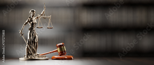 Legal Concept: Themis is the goddess of justice and the judge's gavel hammer as a symbol of law and order on the background of books photo