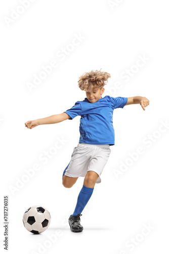 Boy in a football kit kicking a ball © Ljupco Smokovski