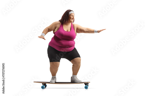 Corpilent woman in sportswear riding a skateboard