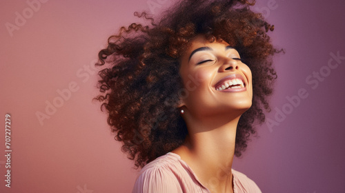 Beautiful african american woman with afro hairstyle on pink background
