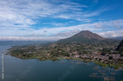 Aerial view of a mountainous landscape with a serene Bali lake