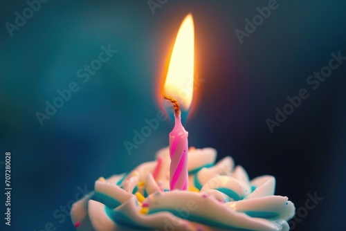 A cupcake with a single lit candle on top. Perfect for birthday celebrations and special occasions