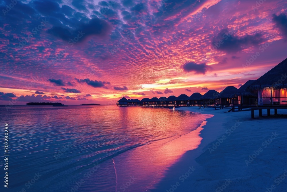 A beautiful sunset view of a beach with a hut on the shore. Perfect for travel and vacation concepts