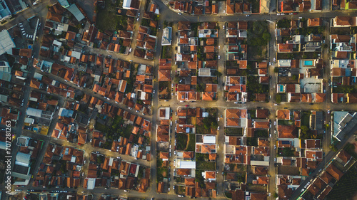 top view looking down of many houses during sunset time in Bueno Brandao, Minas Gerais, Brazil